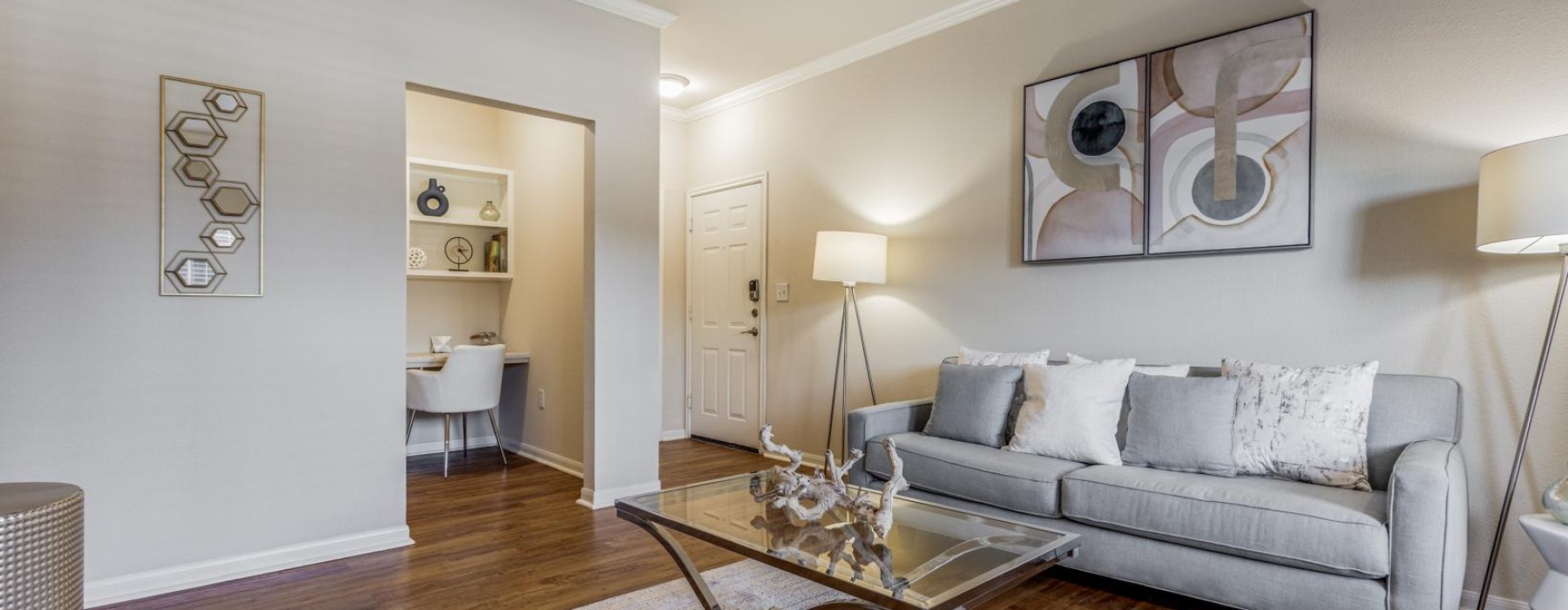 A dresser with books and a vase on top in our lobby at our apartments in Stafford, TX in the 77477 area.