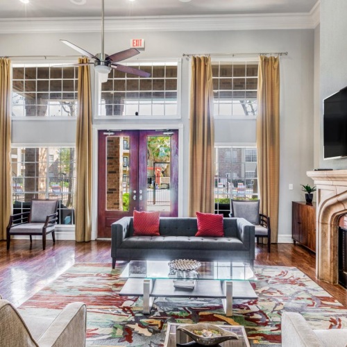 a clubroom with a couch, chairs and a tv