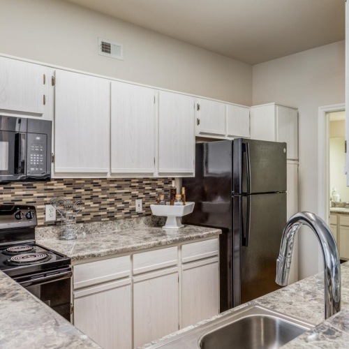a kitchen with marble counters